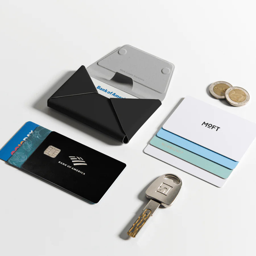 Collection of cards, a key, and a wallet on a white surface