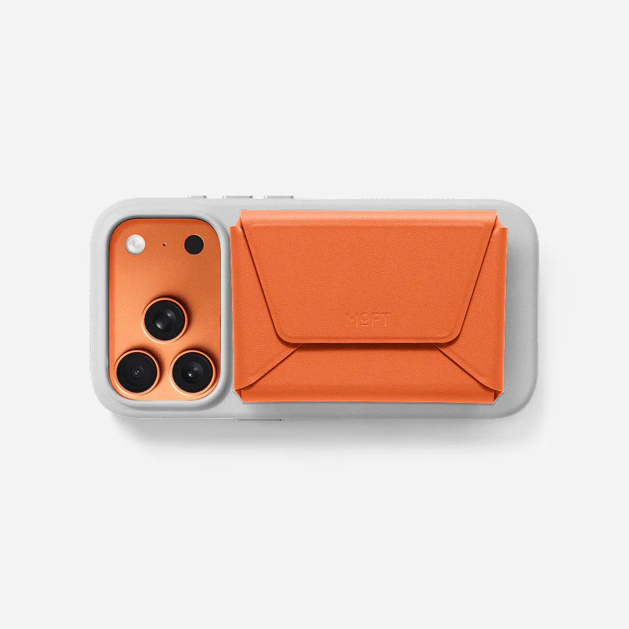 Phone case with orange front and gray moft iphone case back on a white background